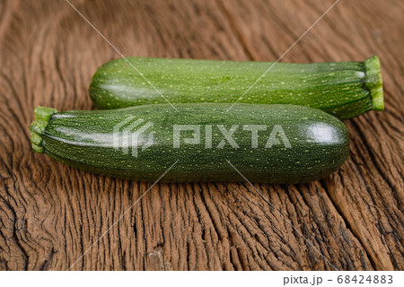 uncooked whole fresh zucchini on wooden background 68424883