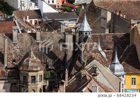 Aerial view on red tiled roofs of medieval Brasov town in Transylvania, Romania. Europe Aerial view on red tiled roofs of medieval Brasov town in Transylvania, Romania. Europe 68428234