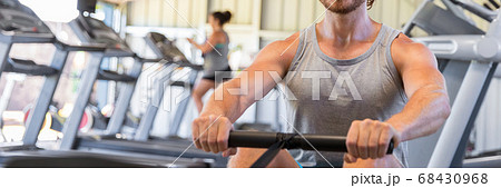 Man training on rowing machine in fitness gym Man training on rowing machine in fitness gym 68430968
