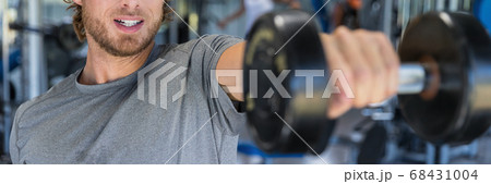 Gym man fitness training arms lifting free weights. Closeup of weight and arm. Unrecognizable male athlete doing dumbbell front raise for shoulder workout wide banner poster Gym man fitness training arms lifting free weights. Closeup of weight and arm. Unrecognizable male athlete doing dumbbell front raise for shoulder workout wide banner poster 68431004