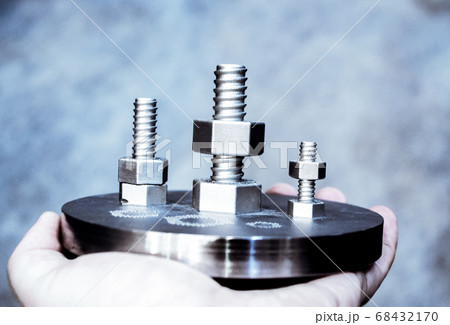 Man is holding object printed on metal 3d printer. Man is holding object printed on metal 3d printer. 68432170