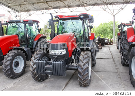 The colorful tractors in the road 68432213