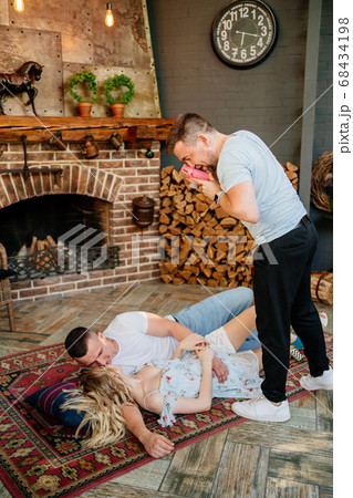lovers on carpet, friend with camera make photos. lovers on carpet, friend with camera make photos. 68434198
