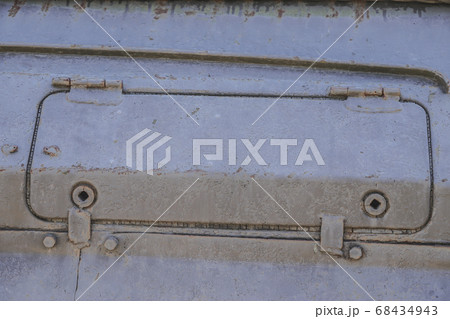 Detail of an old surface with exfoliated paint and rivets on military equipment. Military background Detail of an old surface with exfoliated paint and rivets on military equipment. Military background 68434943