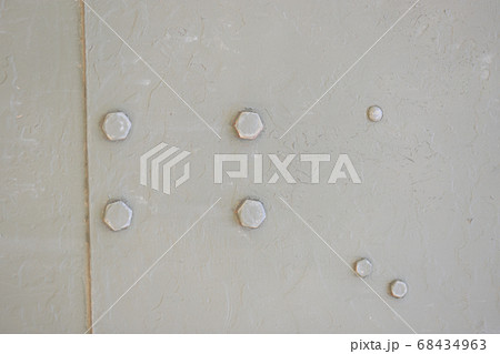Detail of an old surface with exfoliated paint and rivets on military equipment. Military background 68434963