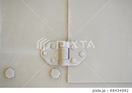 Detail of an old surface with exfoliated paint and rivets on military equipment. Military background 68434992