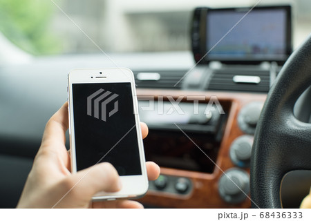 車の中でスマートフォンを操作する⑤ 68436333