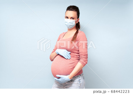 Pregnant Woman in blue gloves against flu and viruses. Healthcare concept. Pregnancy And Infection Pregnant Woman in blue gloves against flu and viruses. Healthcare concept. Pregnancy And Infection 68442223
