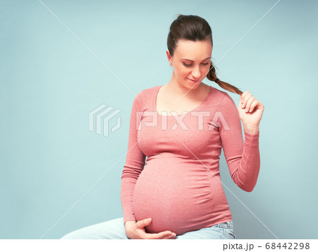 Young beautiful pregnant woman dreams over isolated blue background. Copy space, high resolution 68442298
