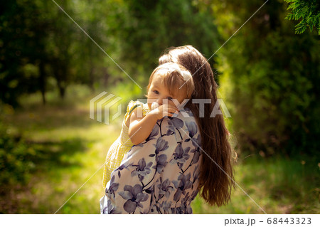 cute little baby girl in yellos dress hugs her cute little baby girl in yellos dress hugs her 68443323