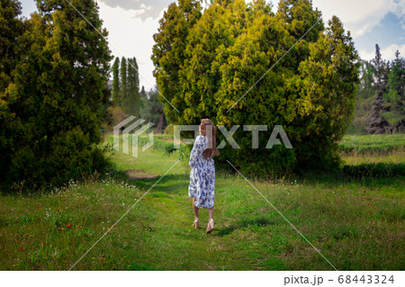 glamour girl walks in long dress at the green park glamour girl walks in long dress at the green park 68443324