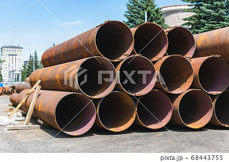 Large, old and rusty sewer pipes stacked in one batch for recycling 68443755