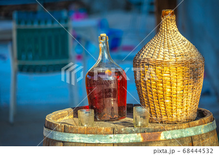 Red wine in a glass barrel and glasses. 68444532