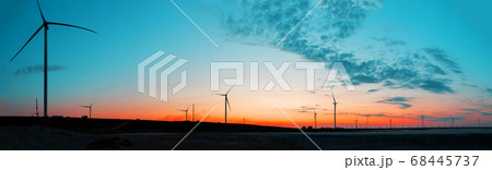 Panorama of wind farm at sunrise Panorama of wind farm at sunrise 68445737