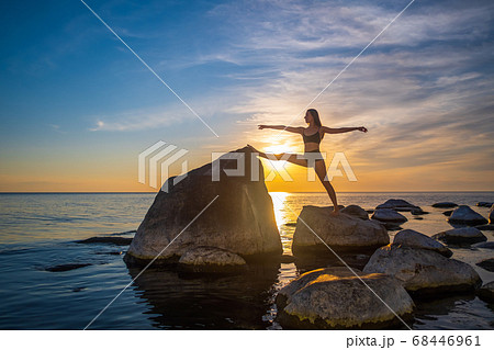 Slim female stretching during sunset Slim female stretching during sunset 68446961