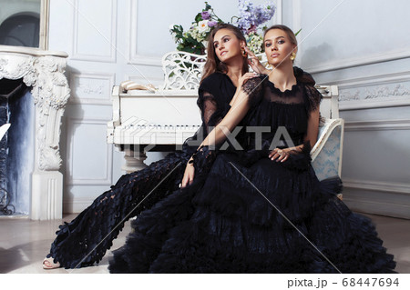 two young pretty lady in black lace fashion style dress posing in rich interior of royal hotel room, luxury lifestyle people concept two young pretty lady in black lace fashion style dress posing in rich interior of royal hotel room, luxury lifestyle people concept 68447694