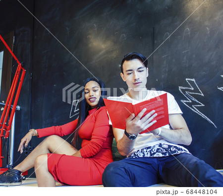 couple students in univercity library, looking book, preparing to exam, having fun, making selfie, lifestyle people concept 68448104