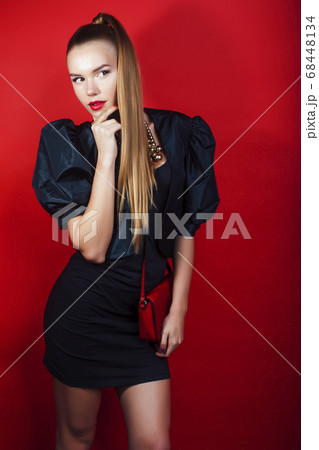 young pretty woman young lady posing on red background wearing gold jewelry, lifestyle people concept young pretty woman young lady posing on red background wearing gold jewelry, lifestyle people concept 68448134