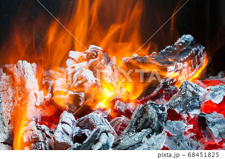 Burning firewood in the fire Burning firewood in the fire 68451825