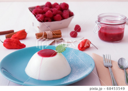 Panna Cotta, traditional sweet Italian dessert with raspberry puree and touch of Bhut jolokia chilli 68453549