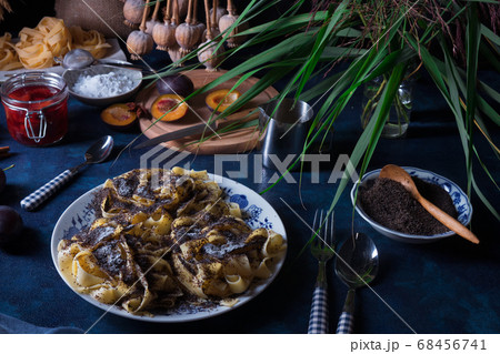Noodles with poppy seeds, Czech traditional sweet pasta dessert with plum compote, dark background Noodles with poppy seeds, Czech traditional sweet pasta dessert with plum compote, dark background 68456741