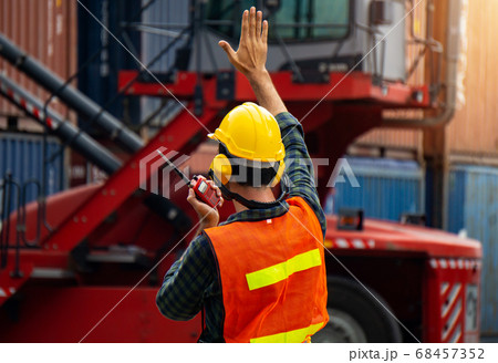 industrial worker is controlling container loading 68457352