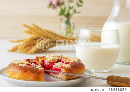 White table with yeasty sweet pastry with fresh currants and raspberries and streusel topping. 68458020
