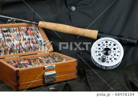 Fly Fishing Equipment and Outdoor Coat - Stock Photo [68458104