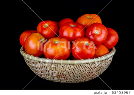 Tomatoes in a Rattan Bowl on a Black Background Tomatoes in a Rattan Bowl on a Black Background 68458967