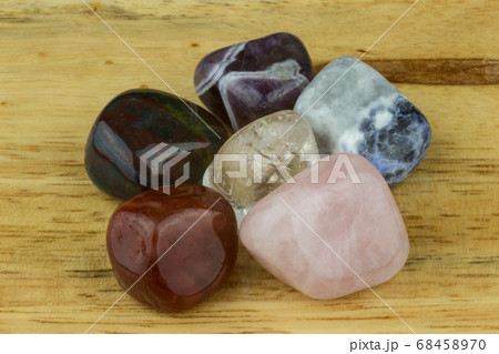 Selection of Stones and Crystals on a Wooden Selection of Stones and Crystals on a Wooden 68458970