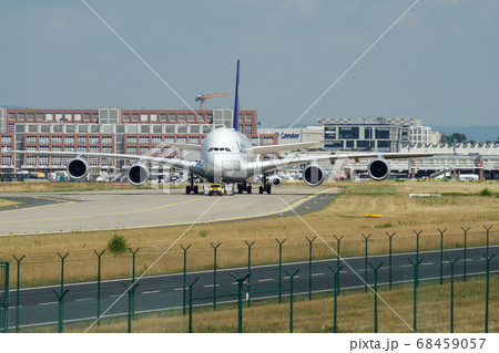 FRANKFURT, GERMANY - JUN 09th, 2017: Airbus A380 of Lufthansa with registration D-AIMH moves on taxiway by tow truck before departure from FRA airport 68459057