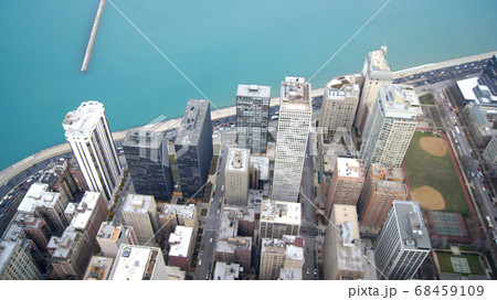 CHICAGO, ILLINOIS, UNITED STATES - DEC 11th, 2015: View from John Hancock tower, Chicago and Lake Michigan panoramic view. City skyline from 360 Chicago observation deck CHICAGO, ILLINOIS, UNITED STATES - DEC 11th, 2015: View from John Hancock tower, Chicago and Lake Michigan panoramic view. City skyline from 360 Chicago observation deck 68459109