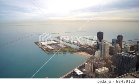CHICAGO, ILLINOIS, UNITED STATES - DEC 11th, 2015: View from John Hancock tower, Chicago and Lake Michigan panoramic view. City skyline from 360 Chicago observation deck CHICAGO, ILLINOIS, UNITED STATES - DEC 11th, 2015: View from John Hancock tower, Chicago and Lake Michigan panoramic view. City skyline from 360 Chicago observation deck 68459122