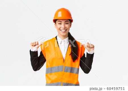 Successful proud smiling asian female construction manager, engineer in safety helmet pointing at herself, show-off. Architect recommend personal assistance, bragging accomplishments Successful proud smiling asian female construction manager, engineer in safety helmet pointing at herself, show-off. Architect recommend personal assistance, bragging accomplishments 68459751