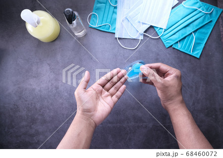 Top view of young man hand using sanitizer gel for preventing virus Top view of young man hand using sanitizer gel for preventing virus 68460072