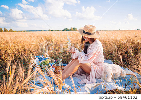 Beautiful girl in wheat field with ripe wheat in hands 68461102