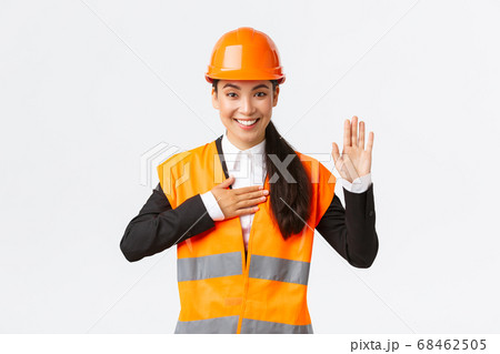 Sincere, honest and confident asian female engineer at building area, making promise, give oath to clients, looking trustworthy, standing in safety helmet, telling truth, white background Sincere, honest and confident asian female engineer at building area, making promise, give oath to clients, looking trustworthy, standing in safety helmet, telling truth, white background 68462505