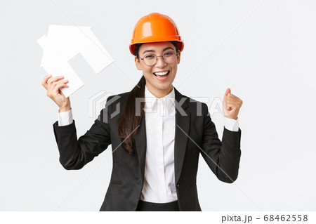 Successful winning asian female construction engineer, team lead architect achieve goal, holding house maket and fist pump in rejoice, celebrating victory in helmet and business suit Successful winning asian female construction engineer, team lead architect achieve goal, holding house maket and fist pump in rejoice, celebrating victory in helmet and business suit 68462558