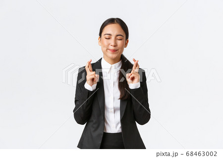 Hopeful optimistic businesswoman having faith in herself, believe dreams come true, cross fingers for good luck and close eyes as making wish, praying for relish, white background Hopeful optimistic businesswoman having faith in herself, believe dreams come true, cross fingers for good luck and close eyes as making wish, praying for relish, white background 68463002