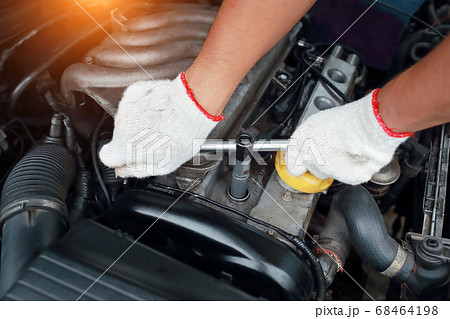 Mechanic hands do maintenance and checking old car engine 68464198