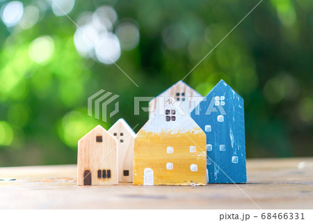 Closed up tiny home model on floor or wood board 68466331
