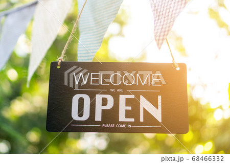 A business sign that says open on cafe or 68466332