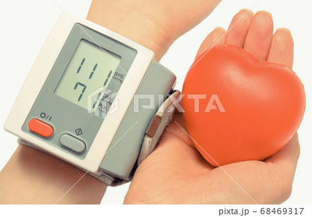 Blood pressure monitor and heart in hand 68469317