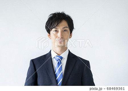 カメラ目線のスーツ姿の若い男性の写真素材