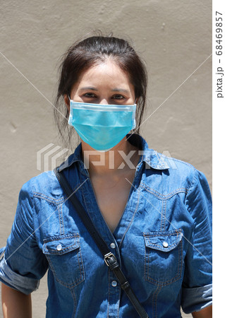 Masked Asian woman prevent germs and wear denim 68469857