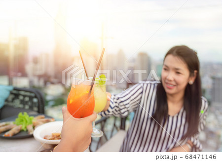 Asian working woman drink mojito cocktail with her Asian working woman drink mojito cocktail with her 68471146