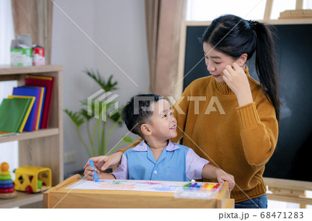Asian teacher in classroom on preschool teach her 68471283