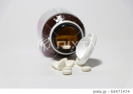 Pile of round white medicine on the floor. Pile of round white medicine on the floor. 68471474