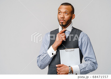 a young african american man holding plain table tablet and pen 68471557