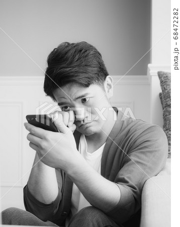 Asian young man rubbing his tired eyes his 68472282